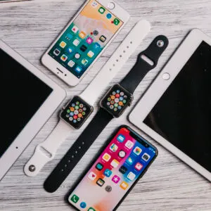 Model wearing minimalist watch with black wristband and white watch face.